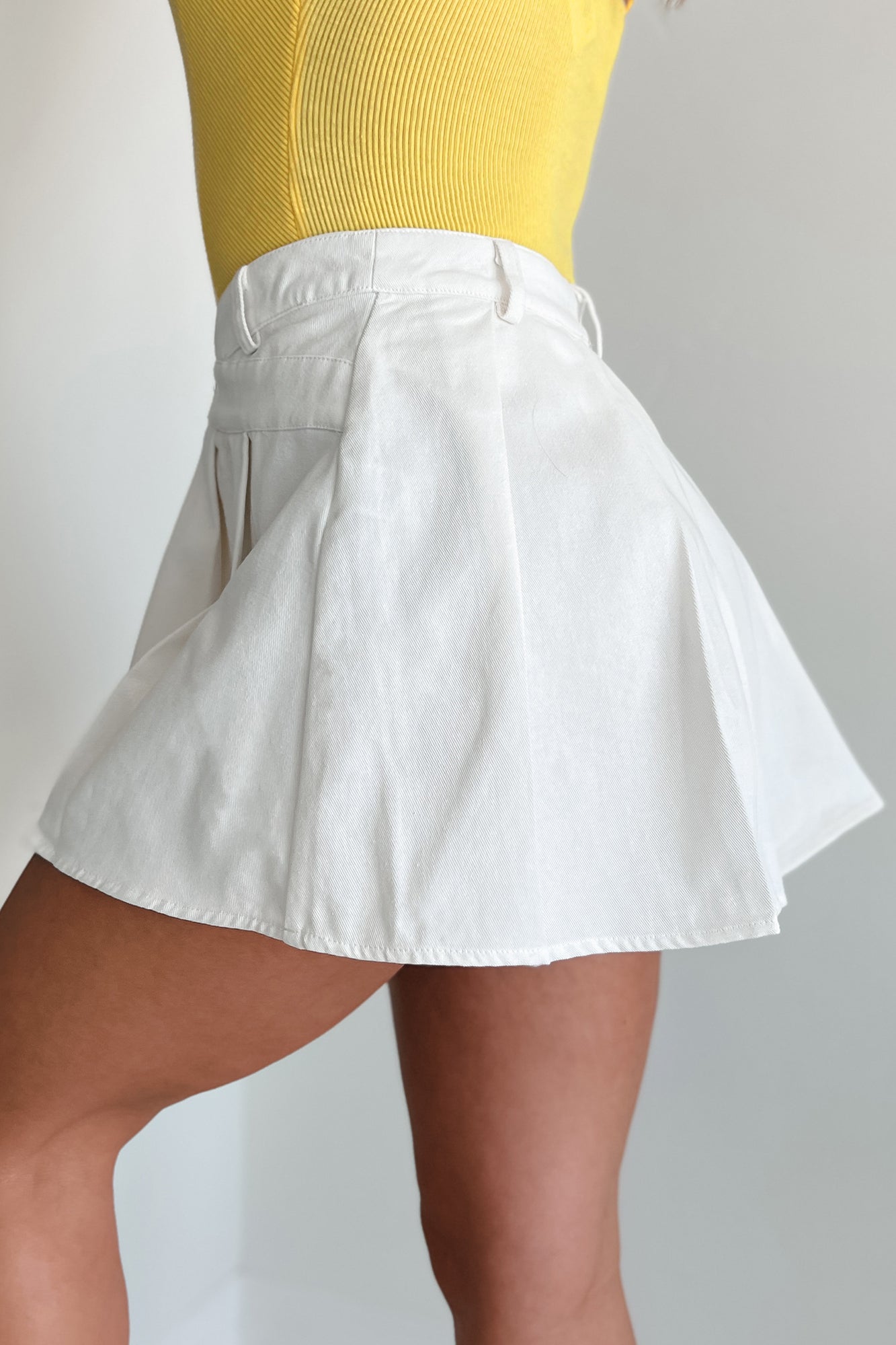 Divine Intuition Pleated Asymmetric Waist Mini Skirt (White)